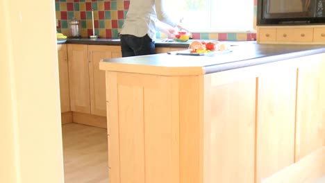 brunette woman rinsing vegetables