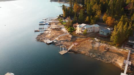 aerial shot of homes with private docks on a beautiful lake during golden hour