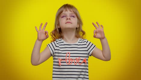 child kid girl breathes deeply with mudra gesture, eyes closed, meditating, keep calm down, relax