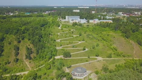 green hill with path on hairpin curves on nice day aerial