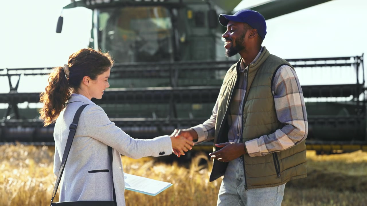 Businesswoman and Farmer Discussing Agricultural Contract in Wheat Field