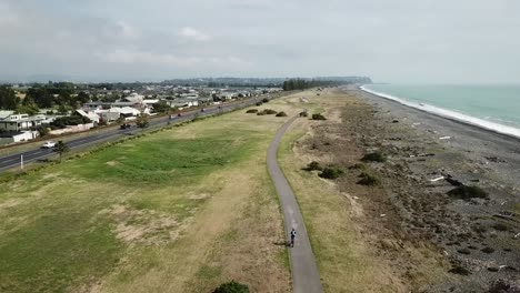 aerial shot, tracking on a person cycling on the bike track in napier, new zealand