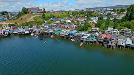 bird's eye view establishing over the colorful palafittes of pedro montt de castro in chiloé, chile on a sunny day