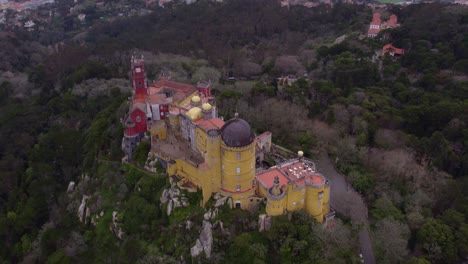 flying over colourful pena palace and national park in sintra, portugal