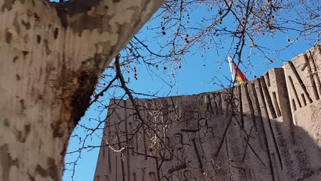 Biggest-Spanish-flag-in-the-world,-located-at-Plaza-de-Colón,-Madrid,-Spain,-Moving-shot-at-60-fps