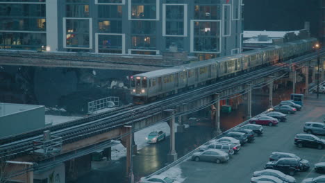 a chicago subway train drives by in the snow in slow-motion