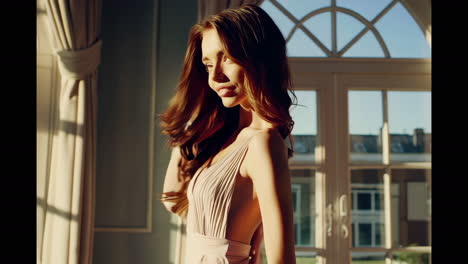 beautiful woman in a dress by the window