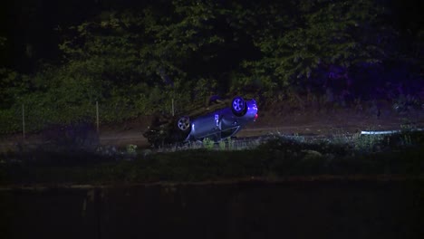 car crash rollover at night along freeway