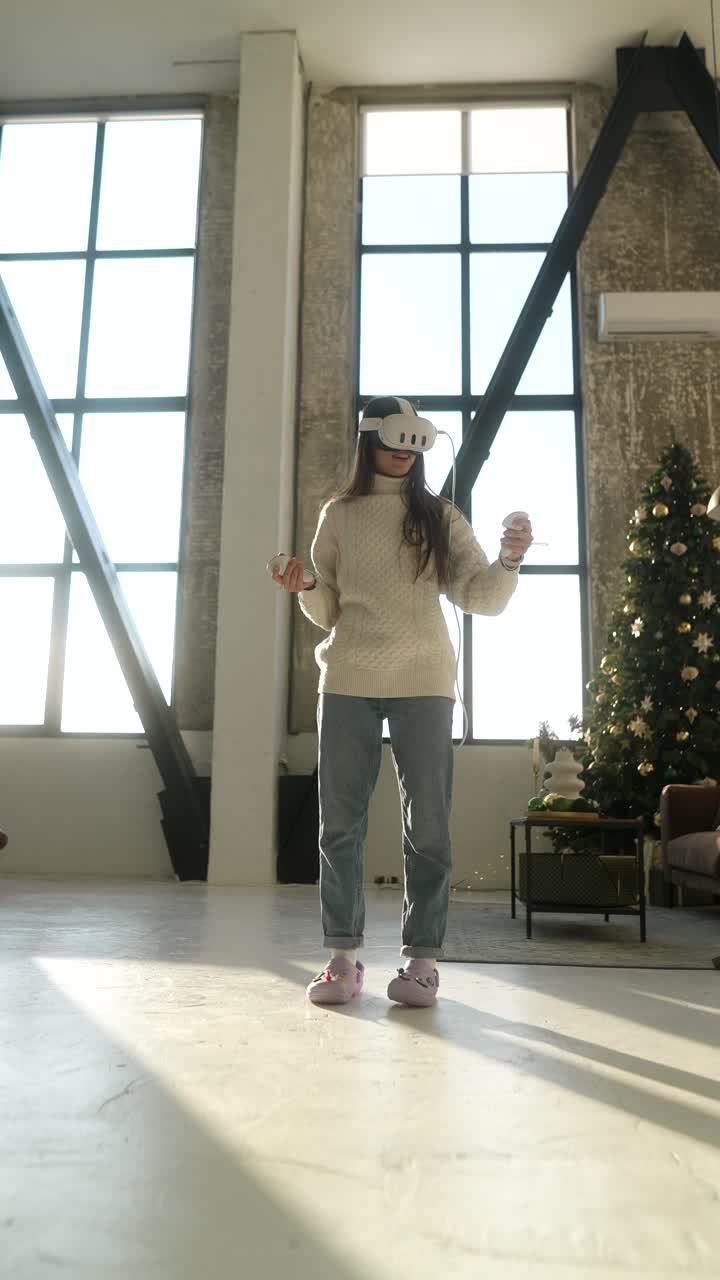 Woman using VR headset in a modern apartment near Christmas tree