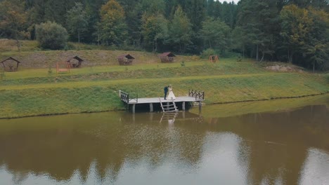 Novio-Con-Novia-Cerca-Del-Lago-En-El-Parque.-Pareja-De-Boda.-Toma-Aérea