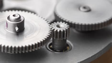 gears rotating in a mechanical device. machine metal gears rotating abstract