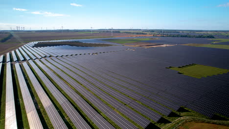 aerial view of big sustainable electric power plant with many rows of solar photovoltaic panels for producing clean electrical energy in poland