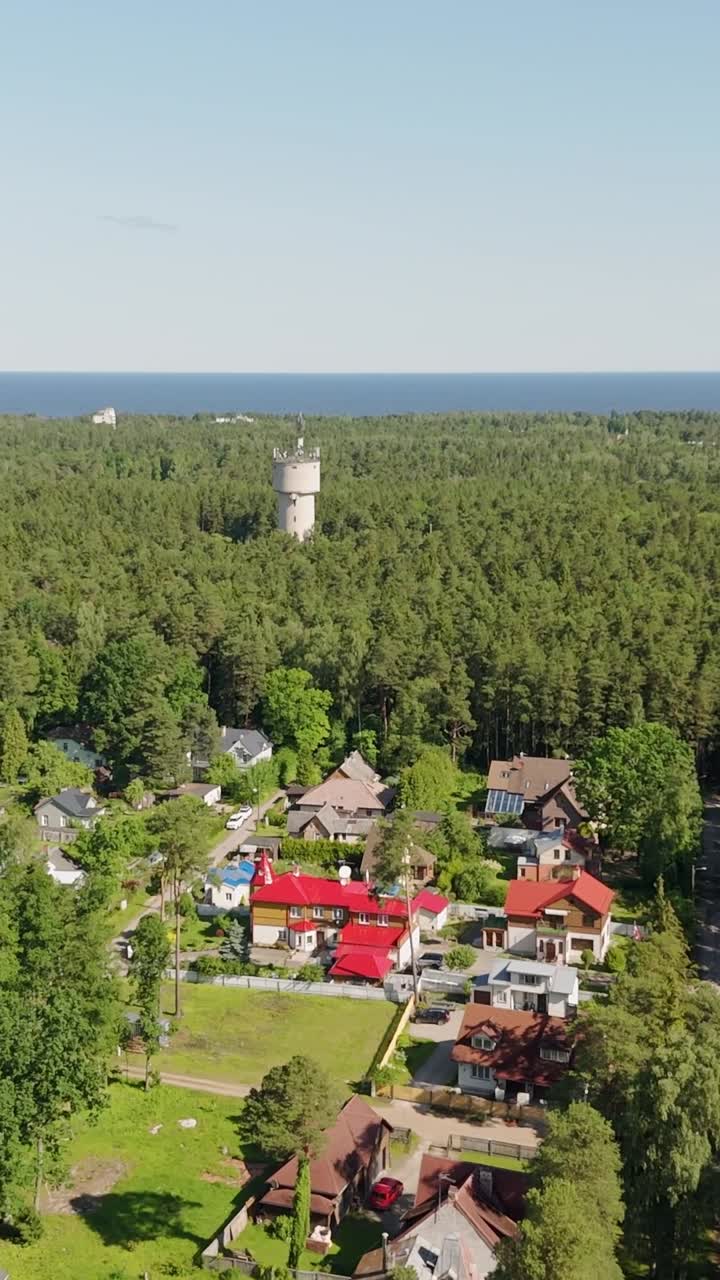 Aerial view of colorful rooftops in Jurmala residential forest neighborhood, vertical