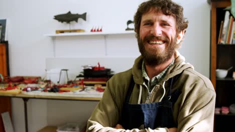 craftsman standing with arms crossed in workshop 4k