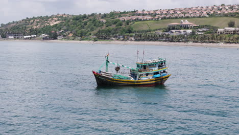 vietnamese style fisherman boat in front of centara resort in mui ne