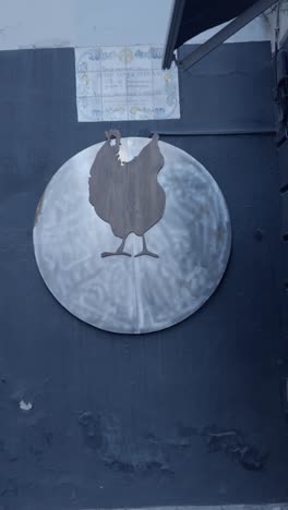 wooden chicken silhouette sign on wall