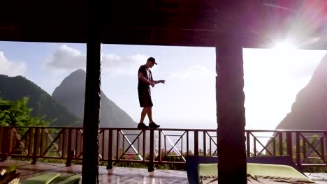 a man walks and dances on a balcony of a luxury hotel room at st lucia caribbean
