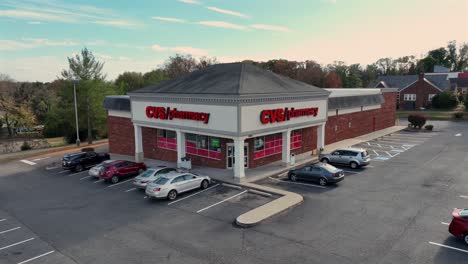 aerial approaching shot cvs pharmacy store with parking cars in usa. sunny day in autumn season. sunny day in suburb district.