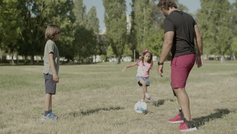 Vater-Mit-Behinderung,-Sohn-Und-Tochter,-Die-Sich-Gegenseitig-Den-Ball-Zuspielen