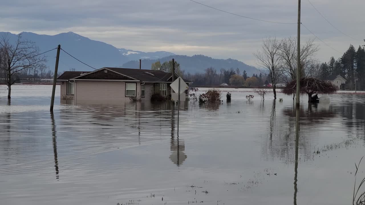 Zoom in and frontal view of house under water from a flood