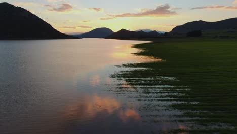 colofrful sunset reflections on lake yliki in greece