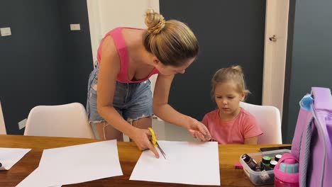 mother and daughter doing arts and crafts at home