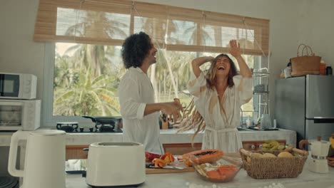 couple dancing in a tropical kitchen