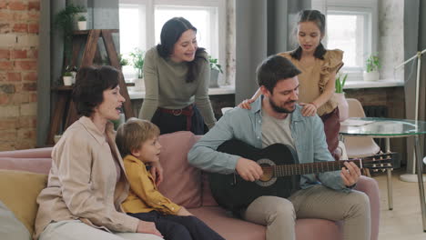family singing and playing guitar at home