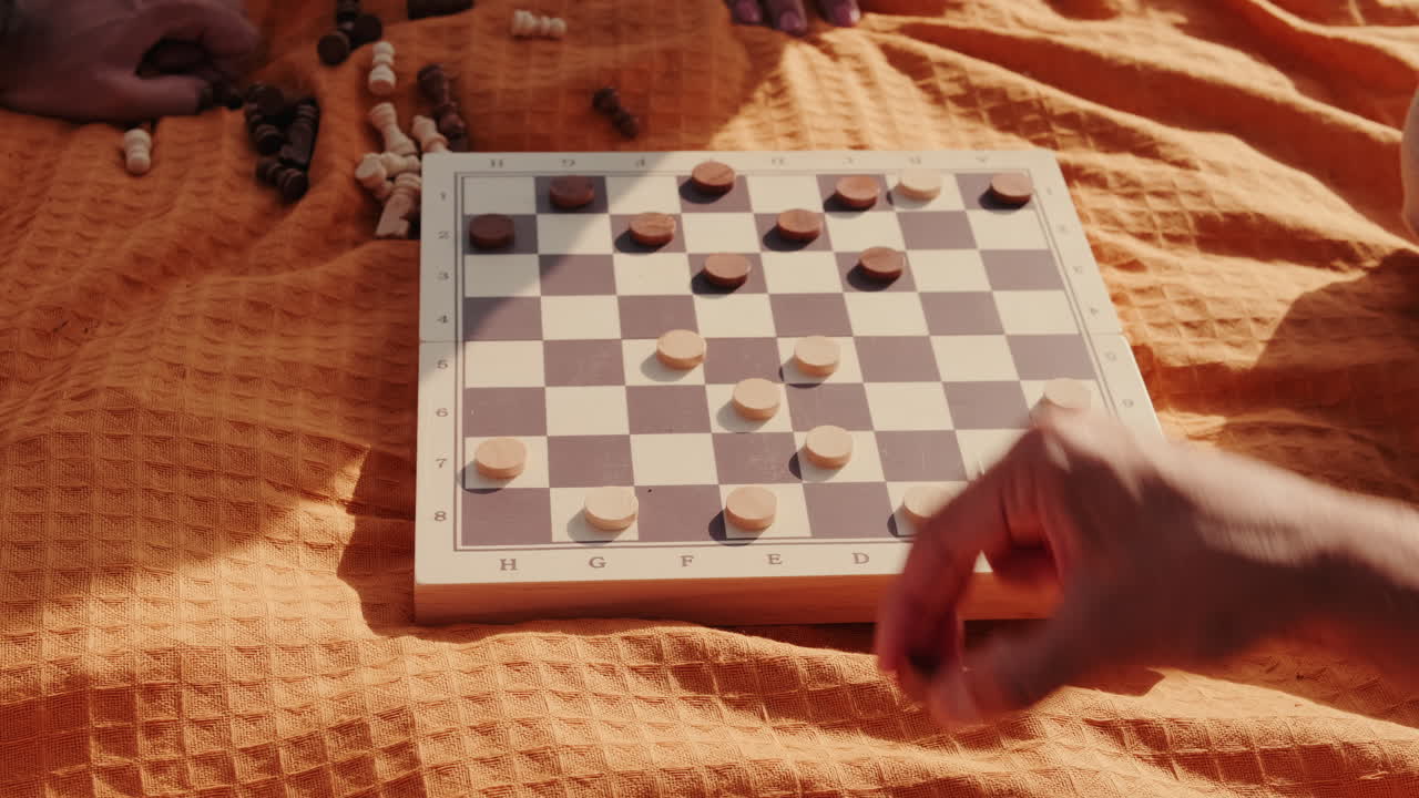 Friends Playing Checkers at a Picnic