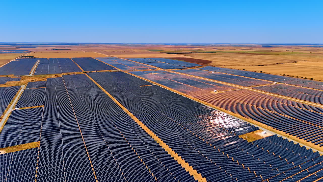 Aerial view of large solar power farm. Drone view of a massive solar panel field generating renewable energy in the open plains