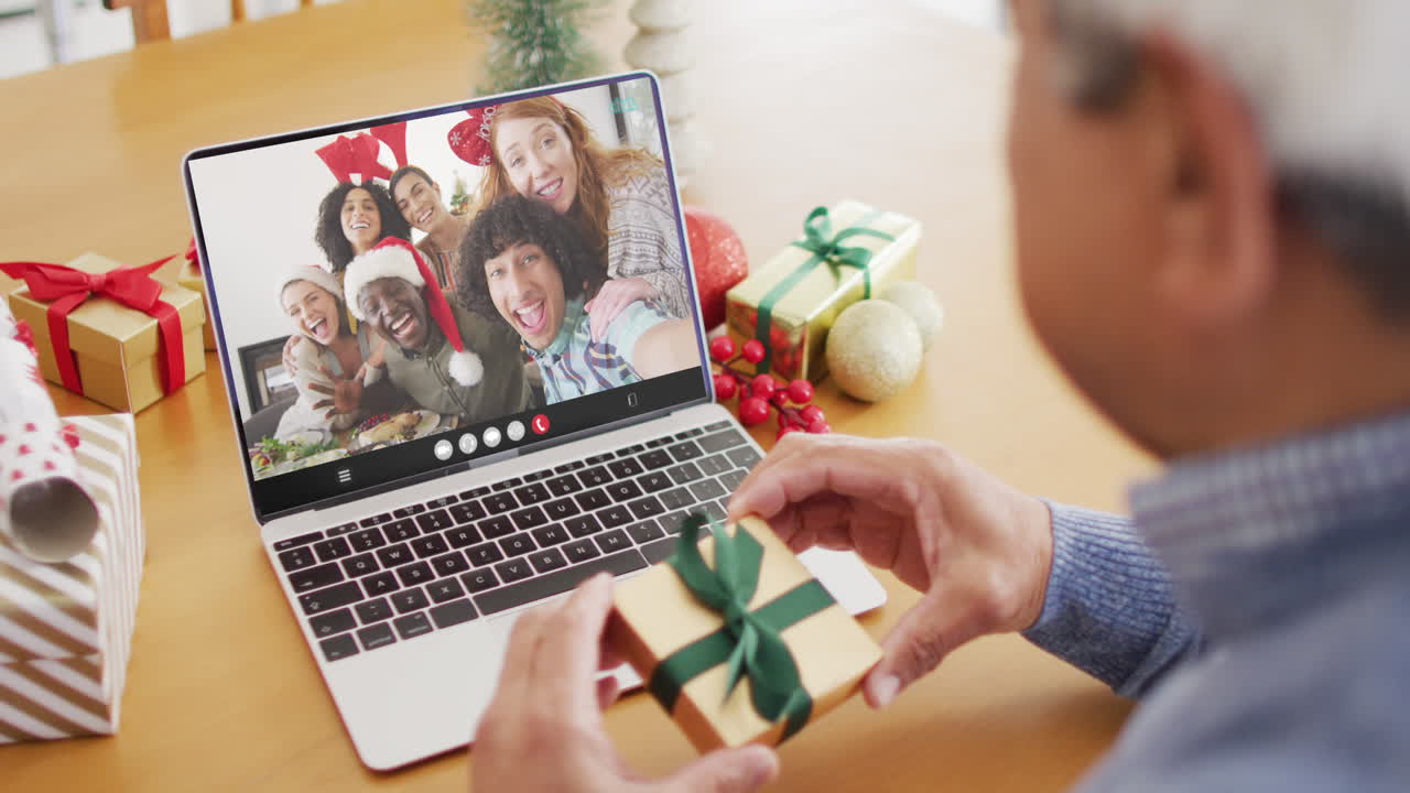 크리스마스 때 가족과 함께 노트북 비디오 통화에서 산타 모자를 입은 두 인종 남자의 애니메이션