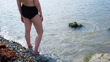 woman on the beach looking out at the water