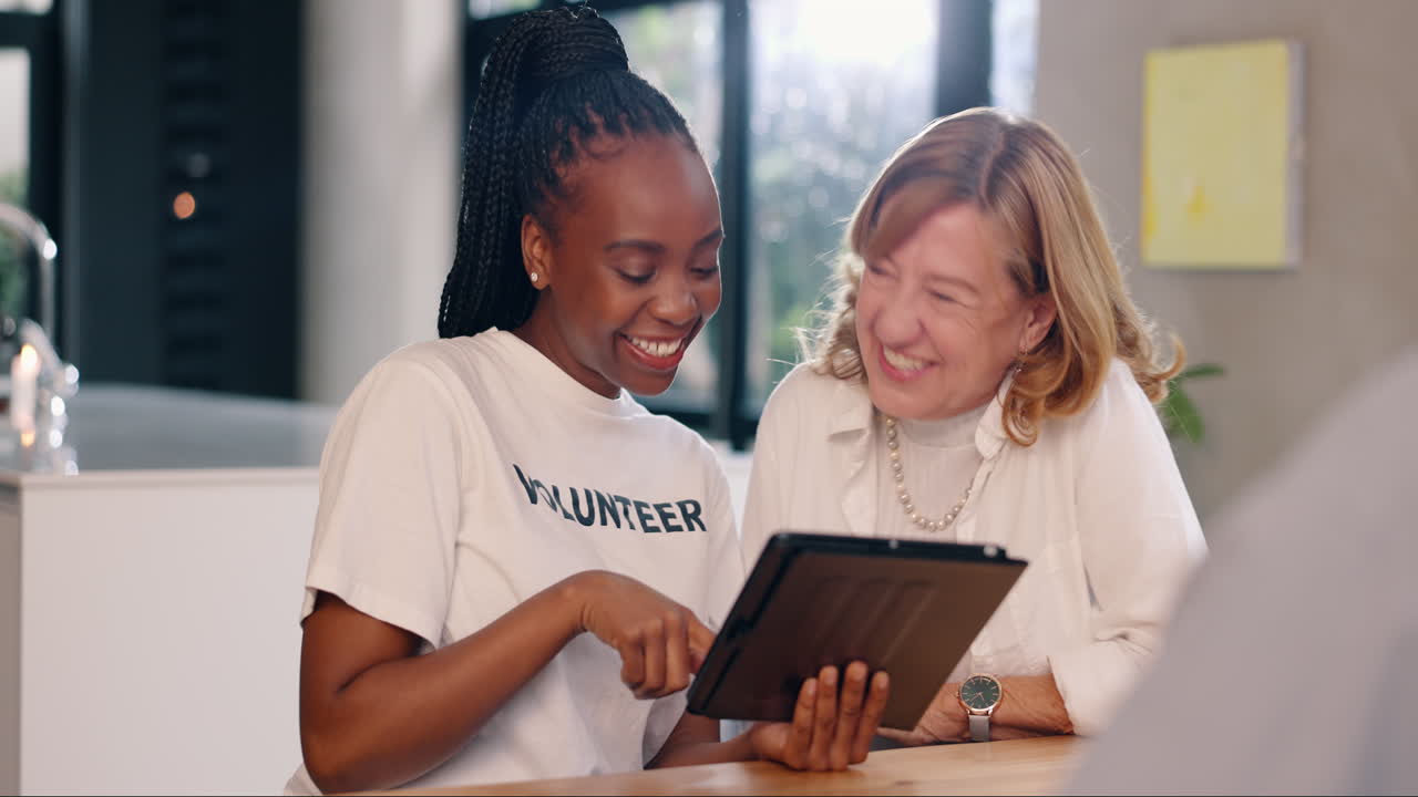 Volunteer helping a senior with technology