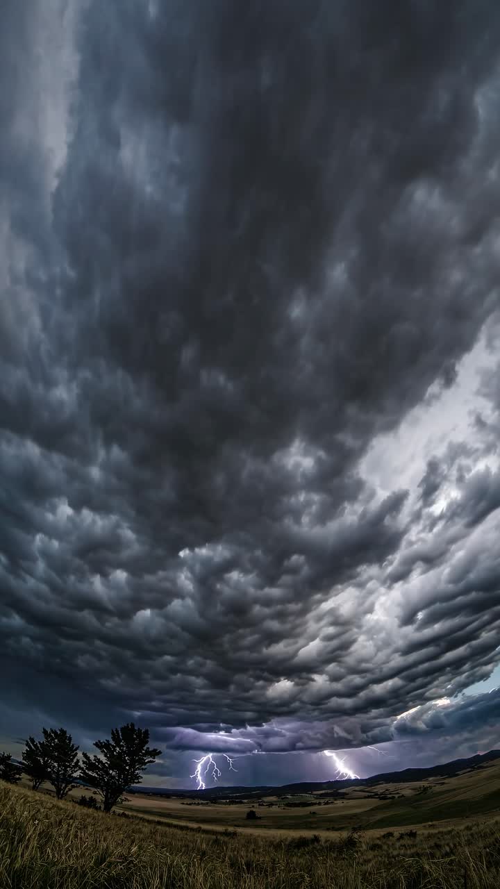 Dramatic wide-angle shot of a stormy sky over a landscape, capturing the ominous clouds