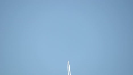 contrails of a commercial aircraft flying in clear sky