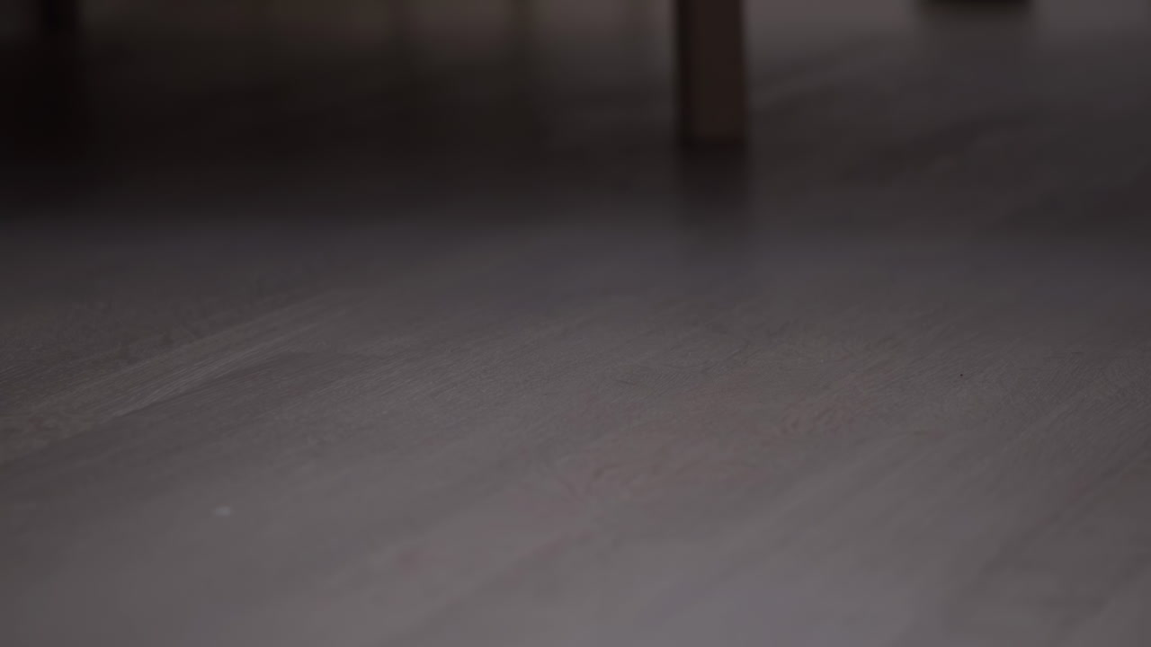 Woman's foot getting out of bed on the linoleum floor