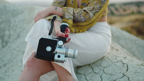 woman holding vintage movie camera