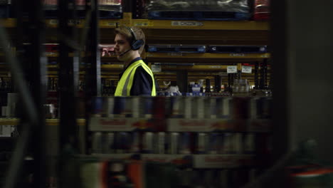 man locating stock in a warehouse, side view, shot on r3d