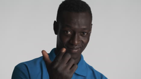 African-american-man-flirting-on-grey-background.