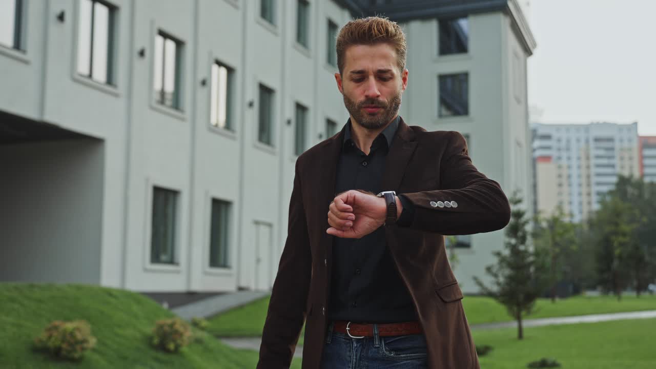 Businessman checking time in front of modern building