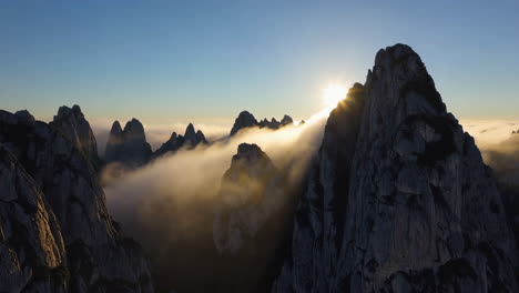 dramatic mountain sunrise with golden light and clouds
