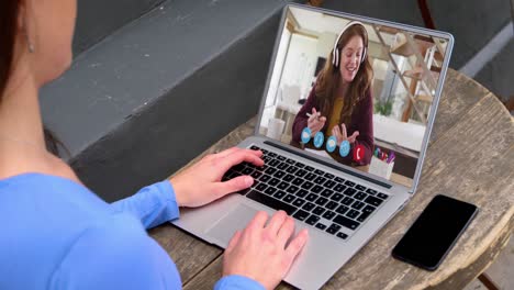 Caucasian-male-teacher-having-a-video-call-on-laptop-with-female-college-student