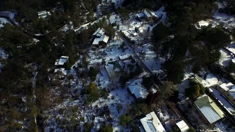 Experience the charm of Blue Mountains&#039; roof houses blanketed in rare snow&mdash;a captivating aerial view showcasing the town&#039;s picturesque, snow-covered landscape