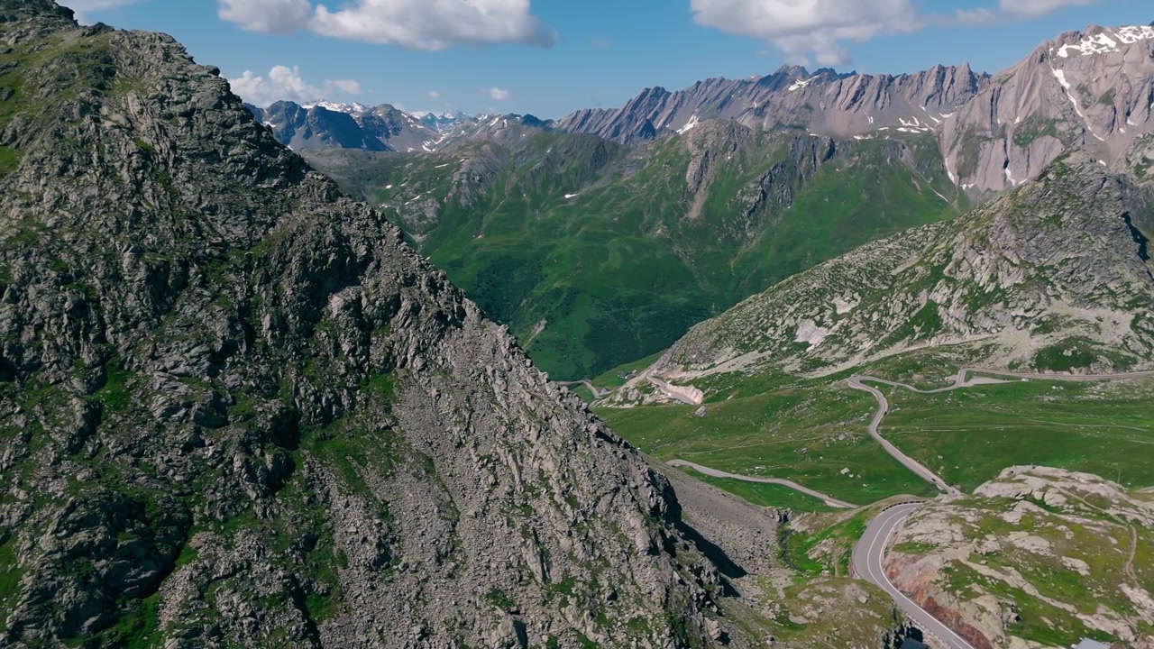 Veduta aerea di montagne rocciose alpine e strada tortuosa vicino al Passo del Gran San Bernardo