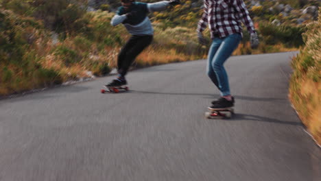 Fröhliche-Multiethnische-Freunde,-Die-Zusammen-Beim-Longboarden-Schnelle-Rennen-Fahren-Und-Spaß-Beim-Fahren-Auf-Der-Landstraße-Beim-Skateboarden-Mit-Schutzhelm-Im-Sommerurlaub-Haben