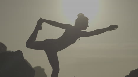 yoga pose silhouette at sunrise/sunset