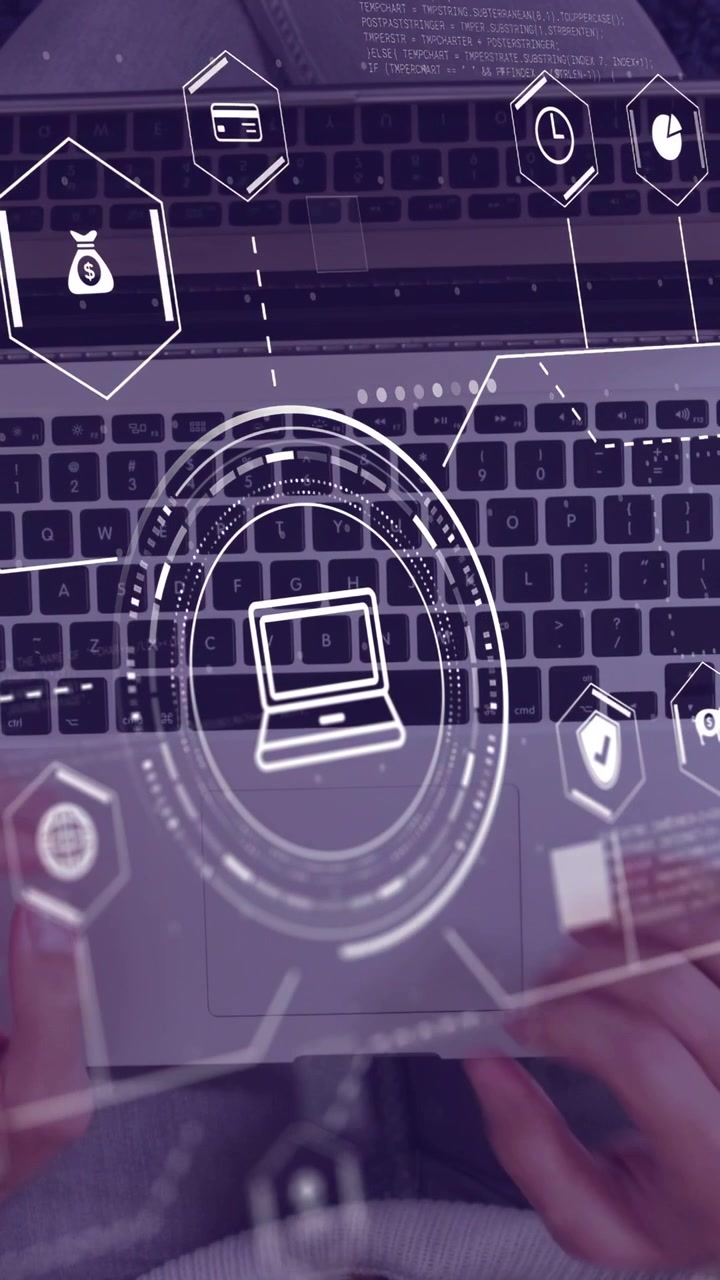 Vertical video: Male holding device above laptop HUD appearing hands typing accessing finance icons