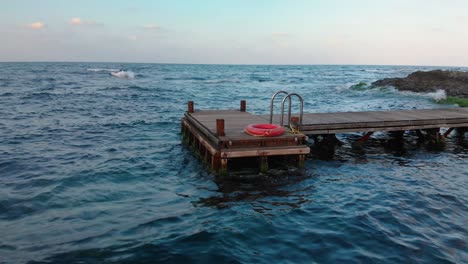 Panning-shot-of-small-wooden-pier,-camera-move-along-the-pier---Lozenets,-Bulgaria