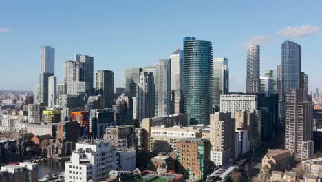 Rising-drone-shot-of-canary-wharf-skyscrapers-London-close-up-sunny-day