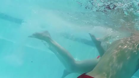 family swimming in pool